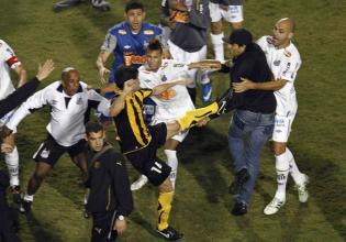 Players of Brazil's Santos and players of Uruguay's Penarol fight after their Copa Libertadores final soccer match in Sao Paulo